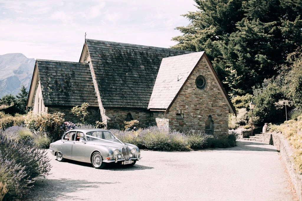 Queenstown New Zealand Elopement Wedding Photographer - Wedding of Dwayne and Cathlyna's silver car parked in front of a church.