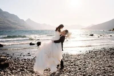 Ayaka Morita's portfolio featuring a bride and groom hugging on the shore of Lake Wanaka.