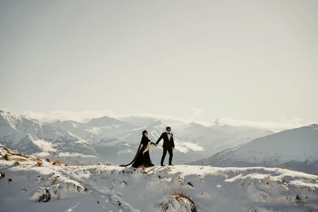 A snow-covered mountain with a bride and groom.