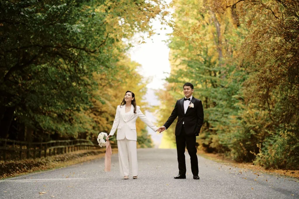 Ayaka Morita's portfolio showcases a bride and groom walking down a road in autumn.
