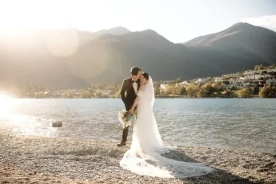 Tracy and Markus' romantic wedding kiss by Lake Wanaka.