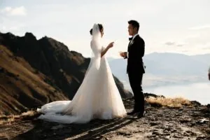 A bride and groom celebrating their Heli-Wedding atop Cecil Peak near Queenstown, NZ.