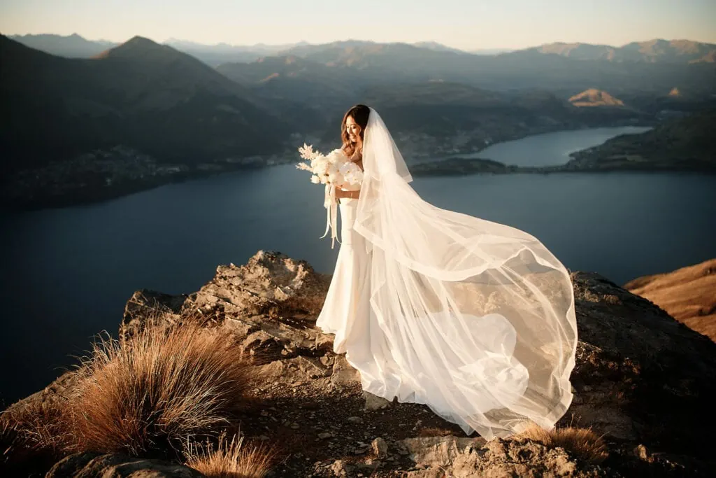 A bride experiences a breathtaking Heli-Wedding on top of Cecil Peak, Queenstown NZ with magnificent views of Lake Wanaka.