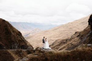 Josh Yates - Portfolio: A couple standing on the edge of a mountain cliff.