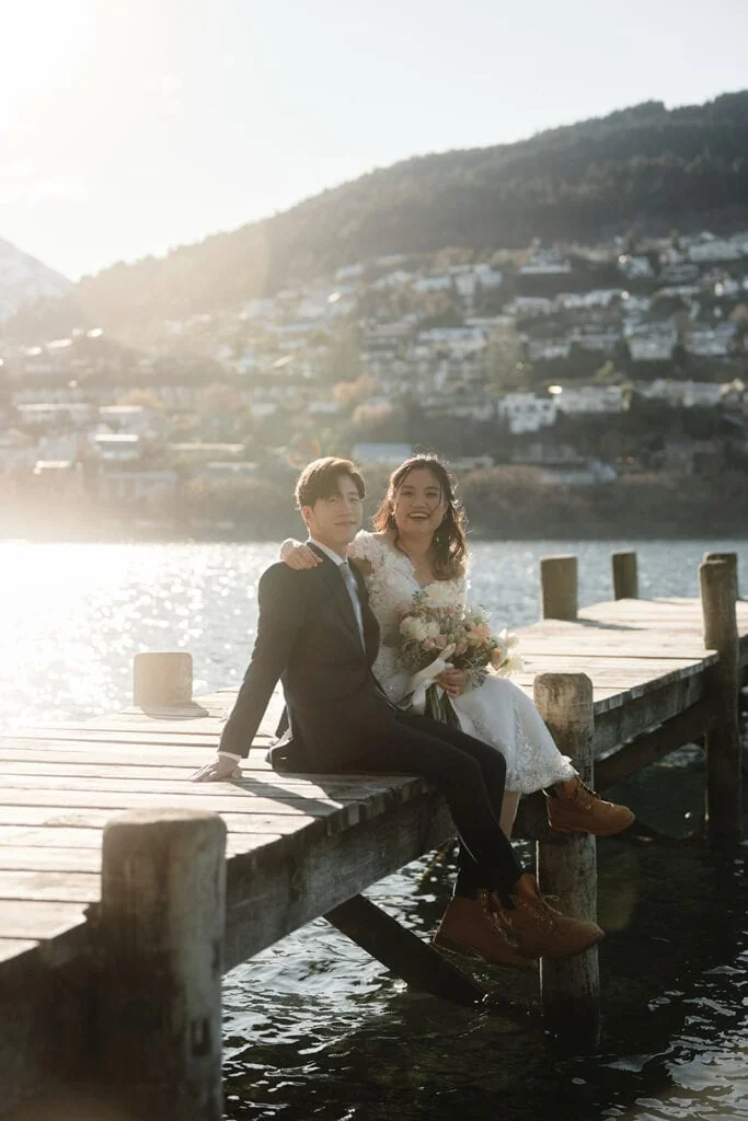 A couple exchanging vows in front of the beautiful Kelvin Heights lake in Queenstown.