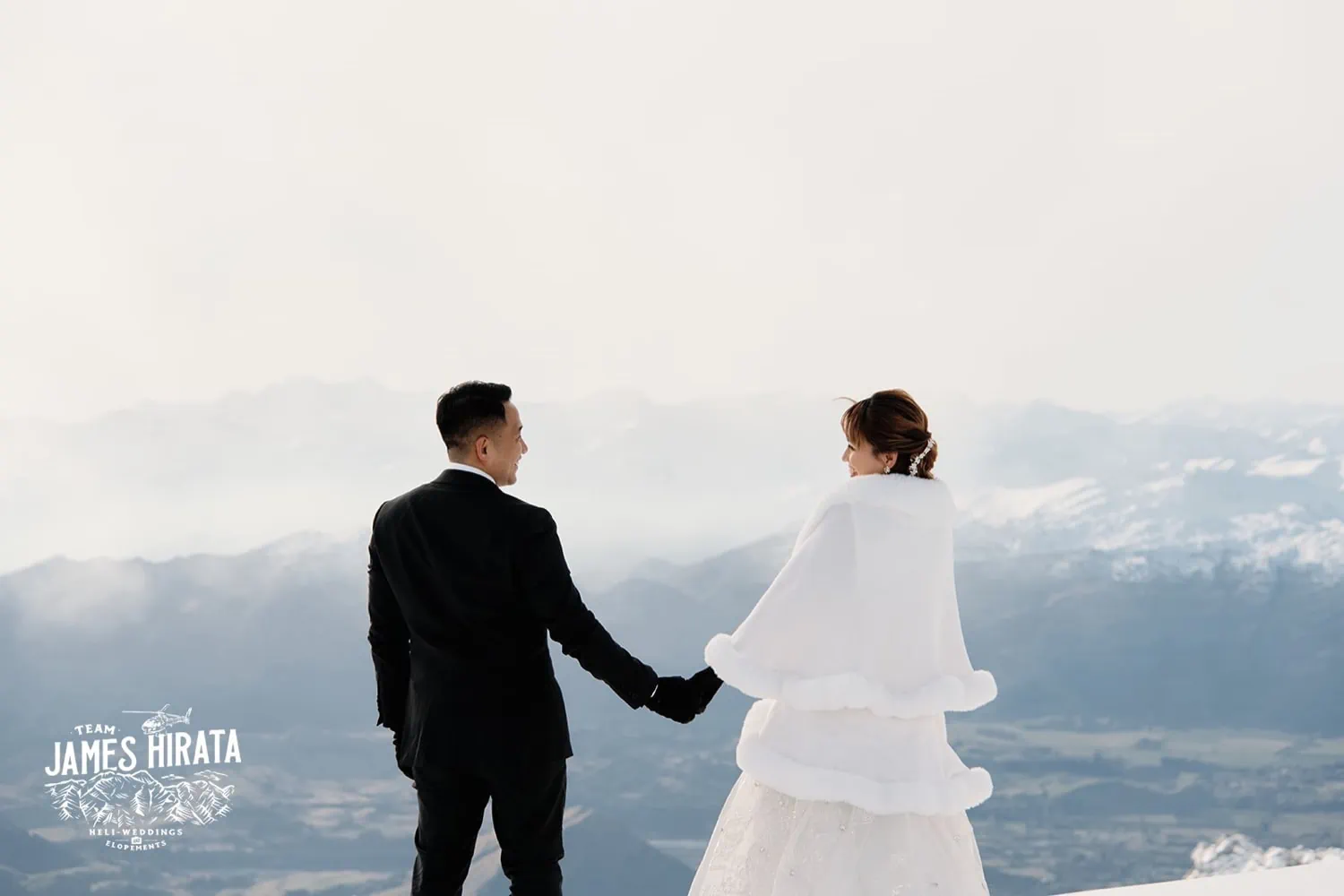 Joan and Brandon's Queenstown Heli Pre Wedding Shoot captures a bride and groom on a snowy mountain.