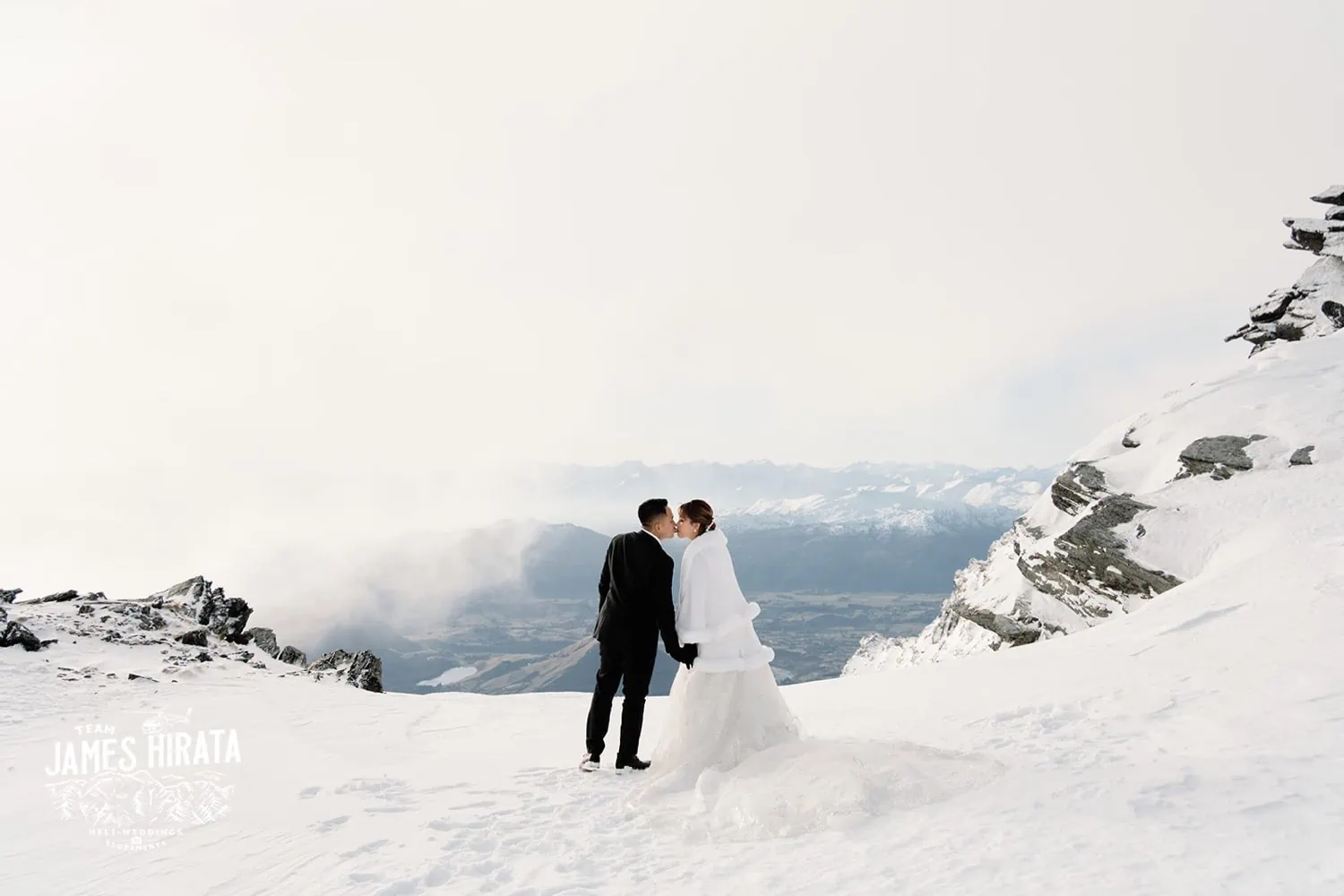 Joan & Brandon's breathtaking Queenstown Heli Pre Wedding Shoot captures a snowy mountain top.