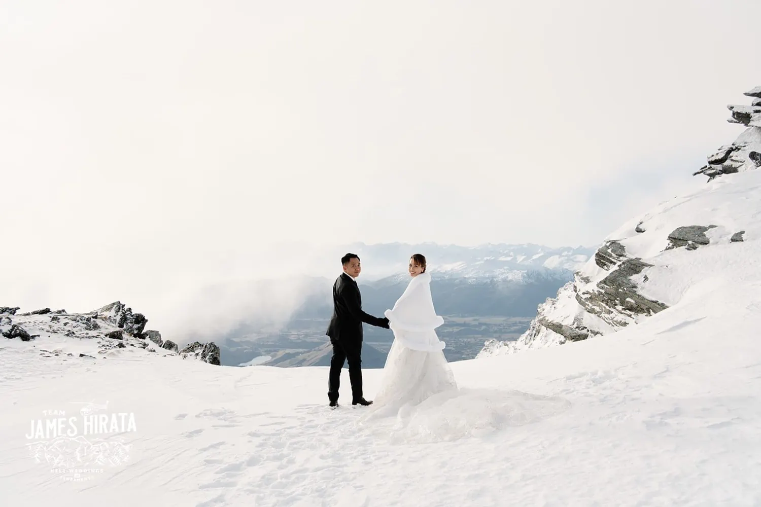 Joan and Brandon embrace at The Remarkables during their heli pre-wedding shoot.