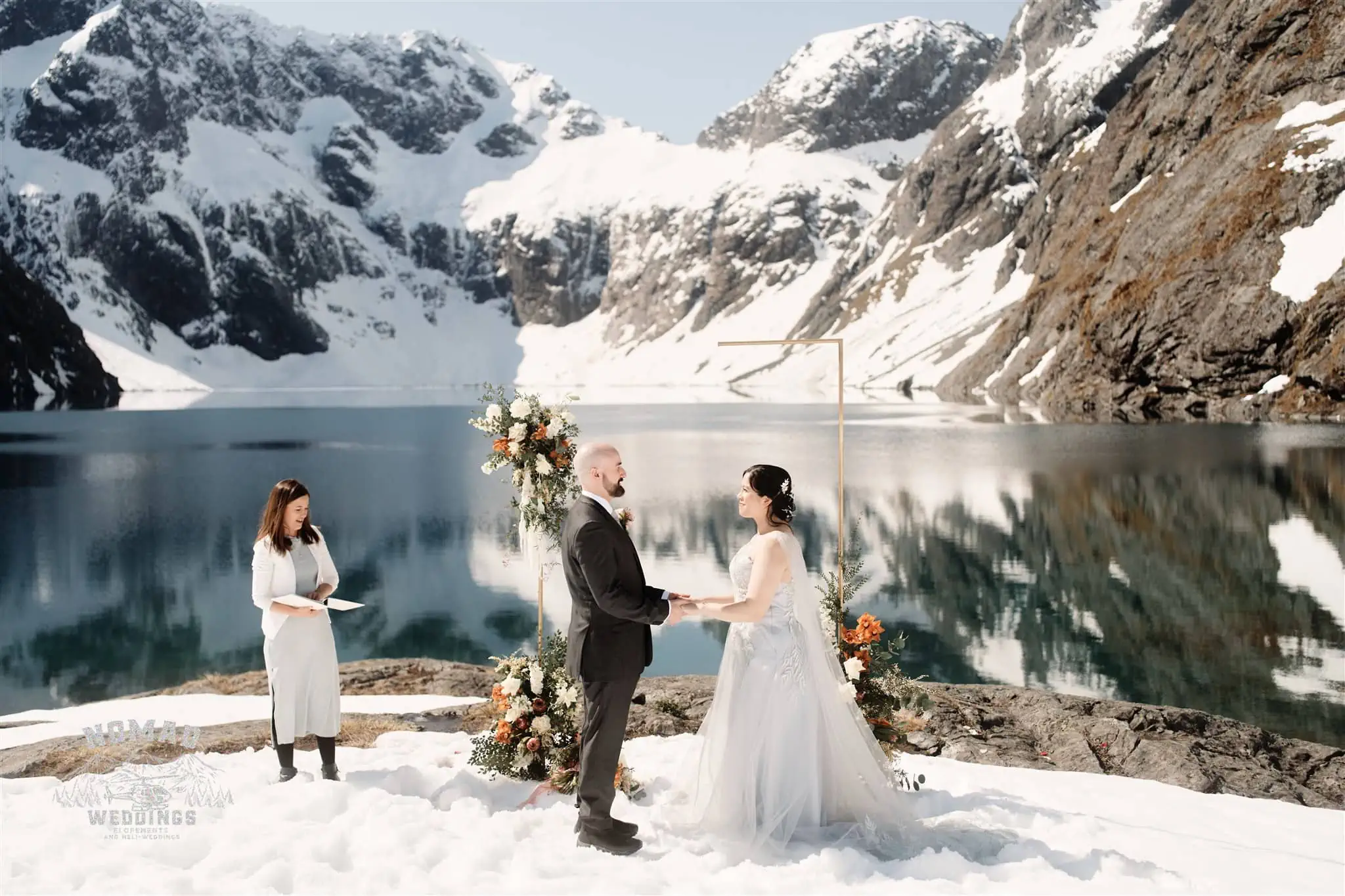 Zoe and Stuart's heli elopement wedding at Lake Erskine with mountains in the background.