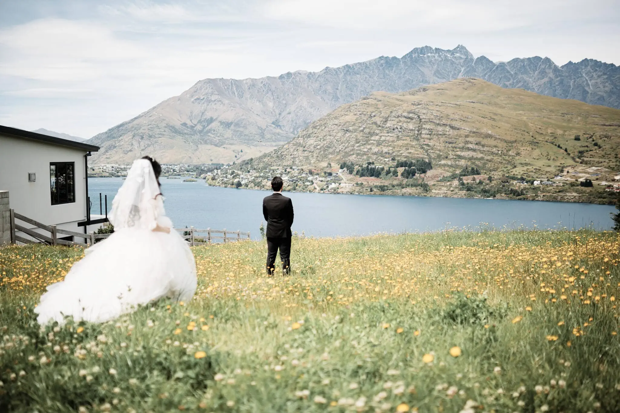 Carlos and Wanzhu exchanging vows during their intimate elopement wedding near a lake.