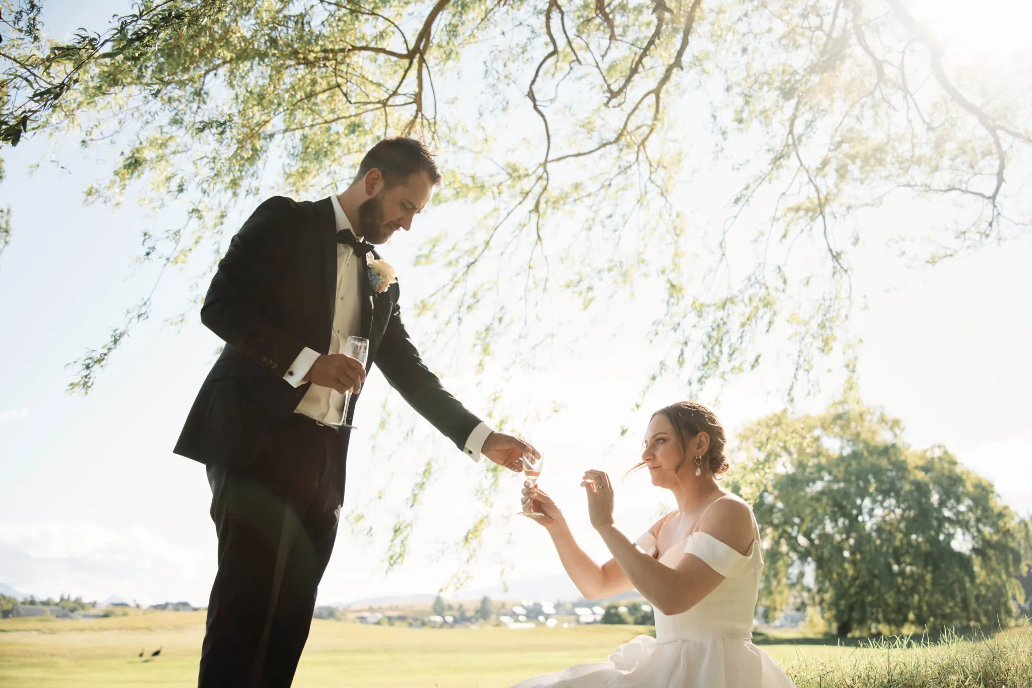 Sapphire and JJ celebrating their Queenstown Heli Elopement Wedding under a tree.
