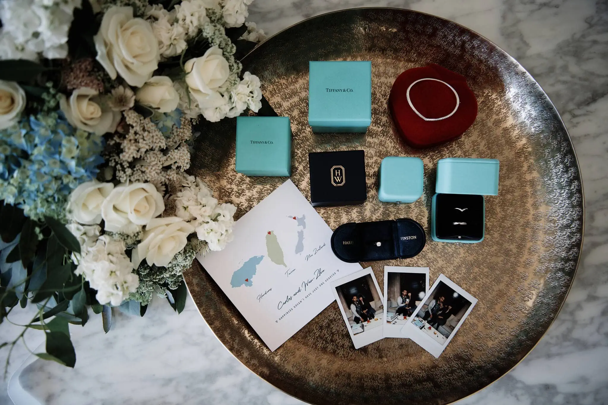 Tiffany & Co engagement ring and other items on a table at Carlos and Wanzhu's intimate Cecil Peak Heli Elopement Wedding.