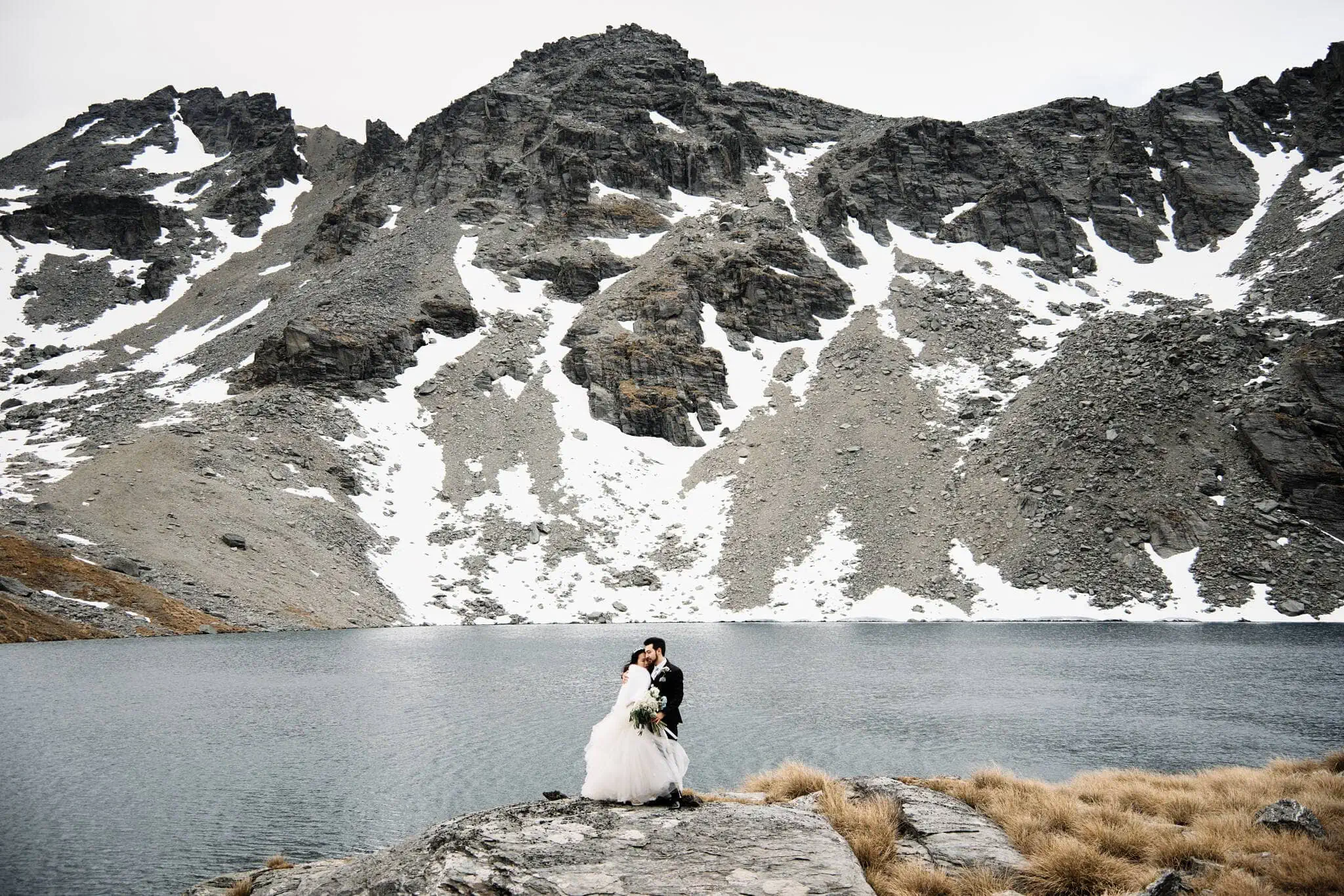 Carlos and Wanzhu's intimate elopement wedding in front of a lake at Cecil Peak.