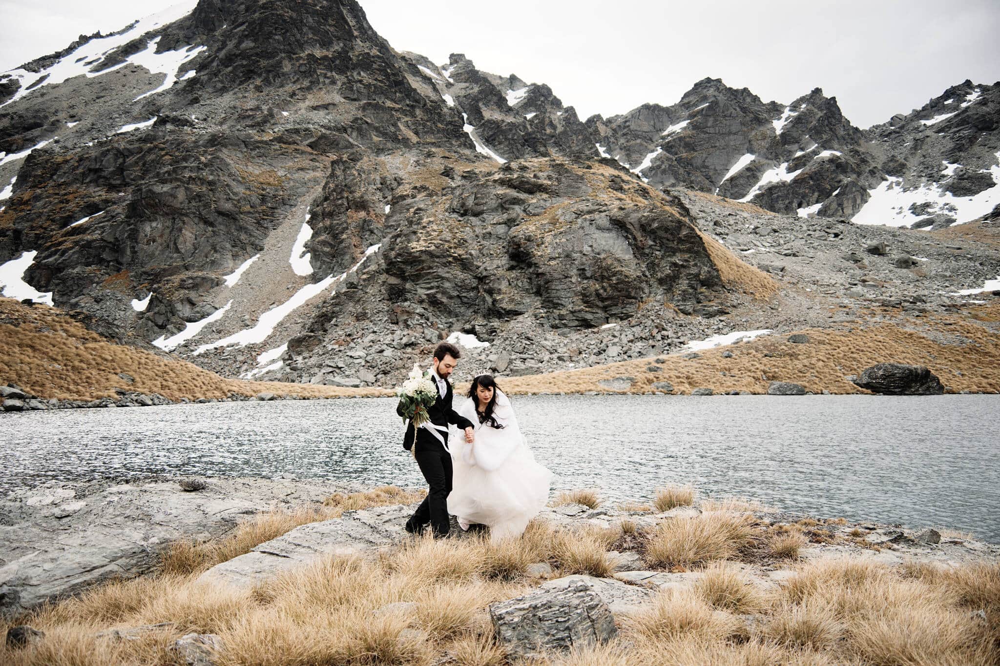 Carlos and Wanzhu's intimate wedding at Cecil Peak, with a mountain lake backdrop.
