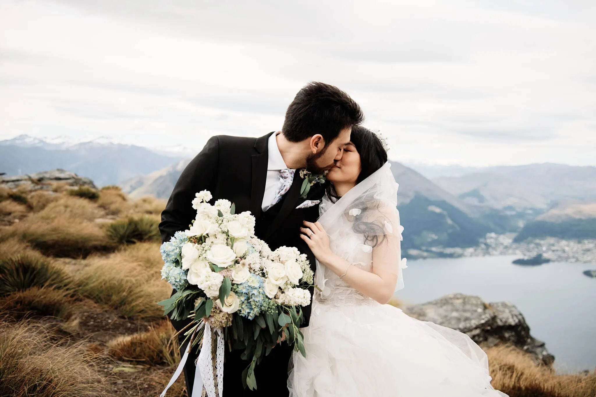Carlos and Wanzhu's intimate Cecil Peak heli elopement wedding with a mountain backdrop in Queenstown, New Zealand.