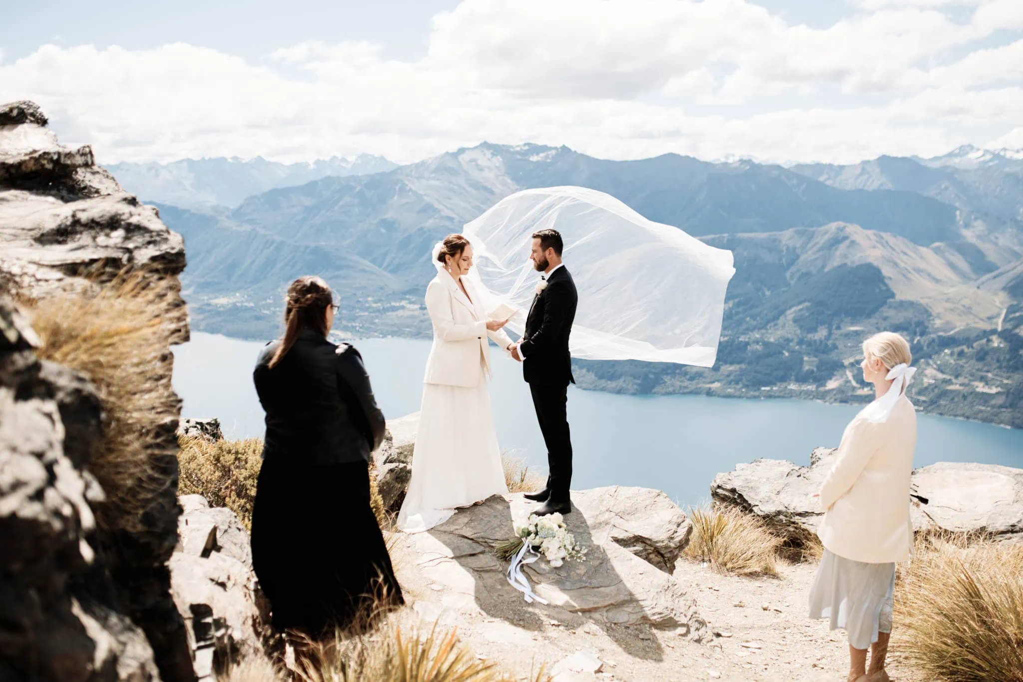A Sapphire and JJ couple celebrating their Queenstown Heli Elopement Wedding atop a mountain in New Zealand.