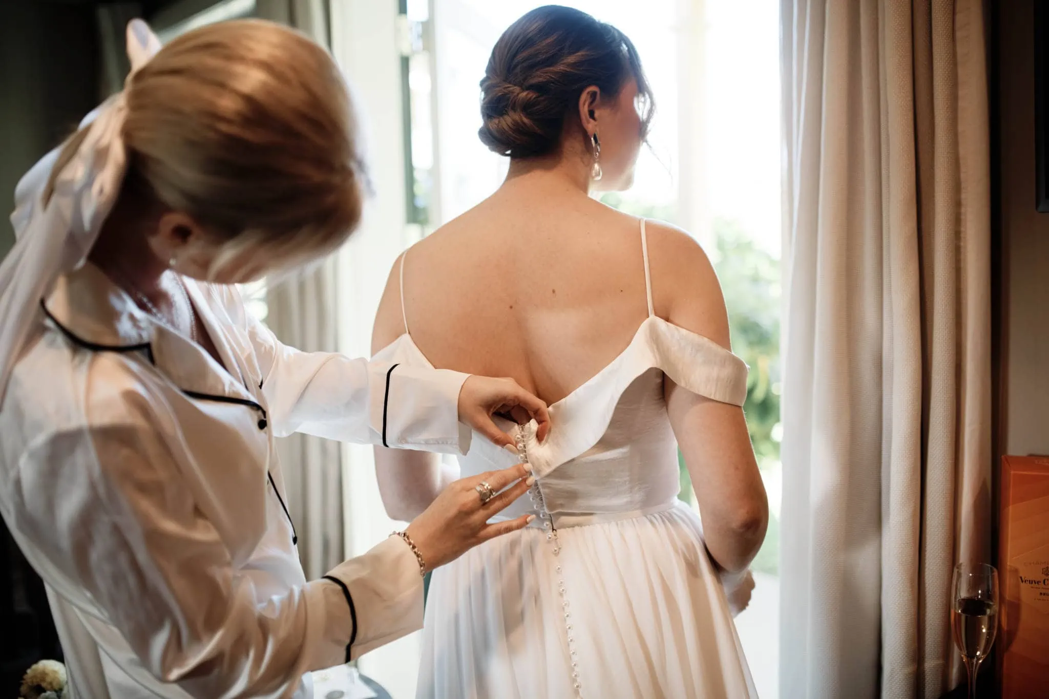 A Queenstown bride wearing a sapphire wedding dress near a window.