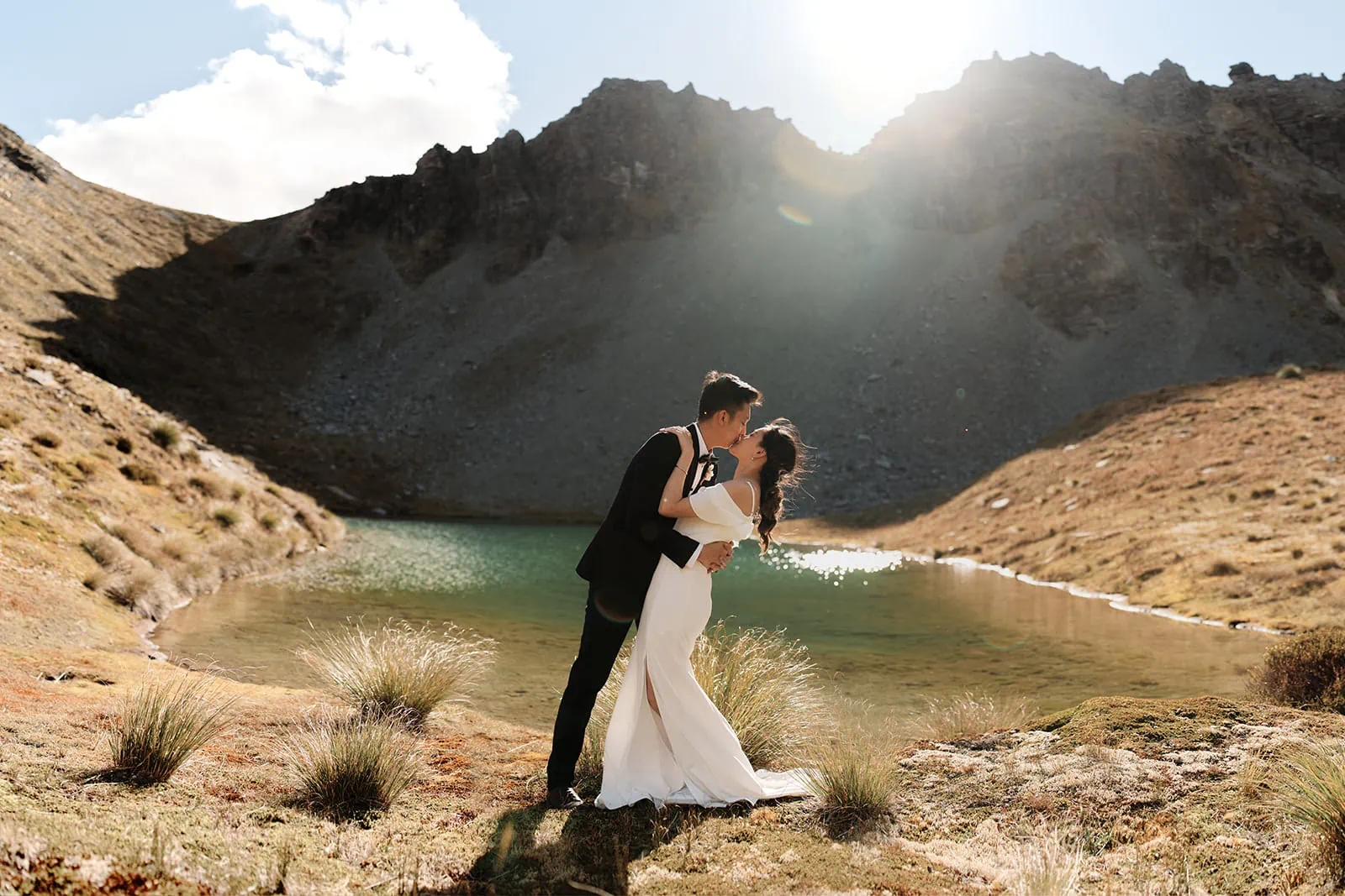 Keywords: bride, groom, kiss, lake, mountains.