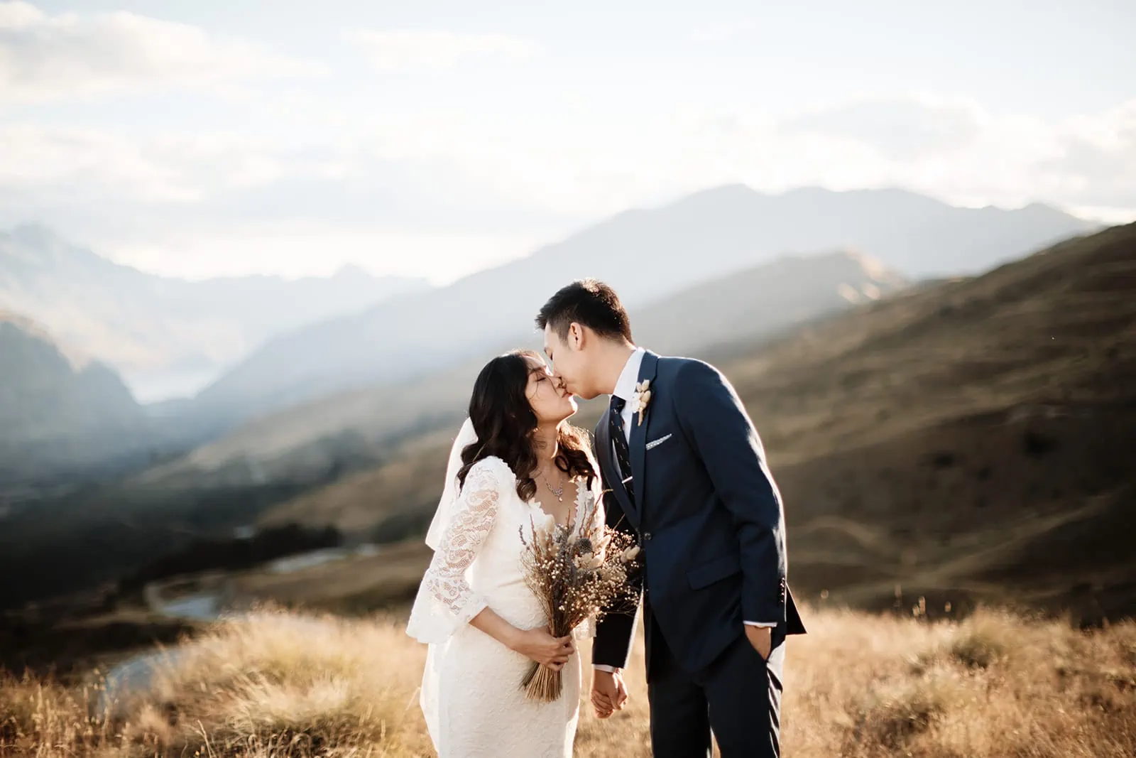 Dios and Carlyn share a kiss in the mountains during their Queenstown Heli Pre Wedding at Cecil Peak.