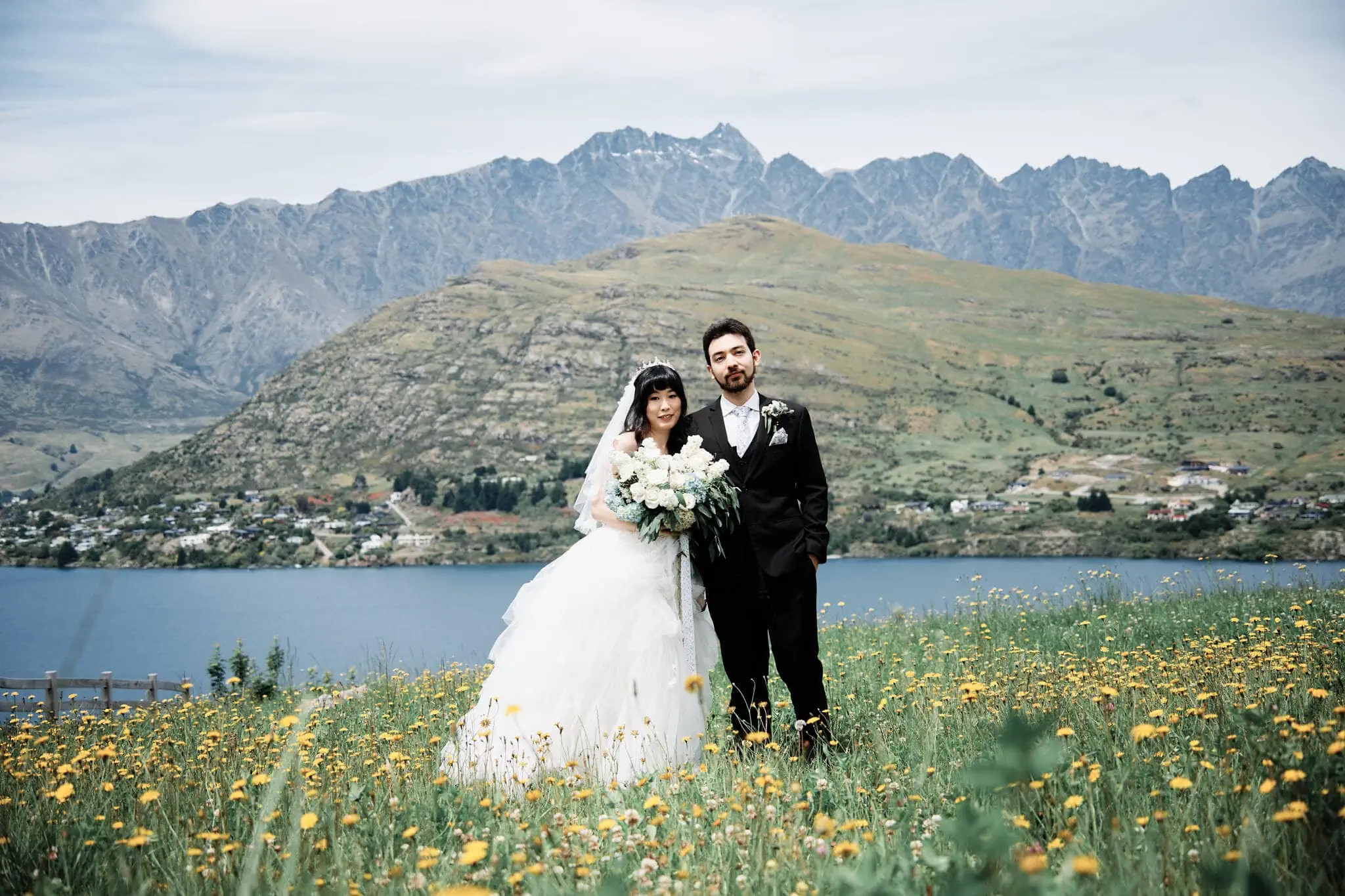 Carlos and Wanzhu's intimate elopement wedding on Cecil Peak with mountains in the background.