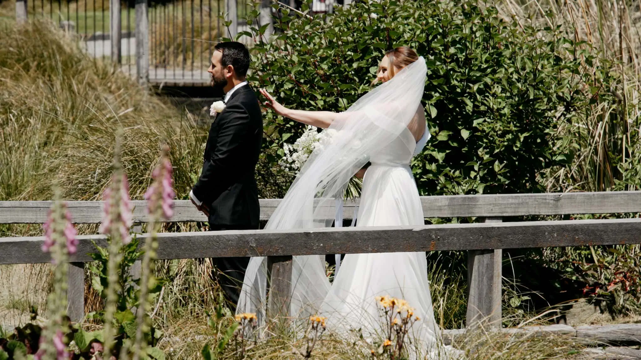 Sapphire and JJ's Queenstown Heli Elopement Wedding: A bride and groom on a bridge.