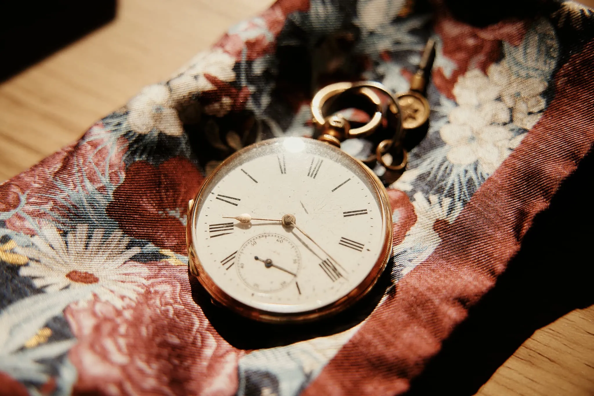 Claire and Rob's elopement wedding at Cecil Peak featuring a pocket watch on a piece of fabric.