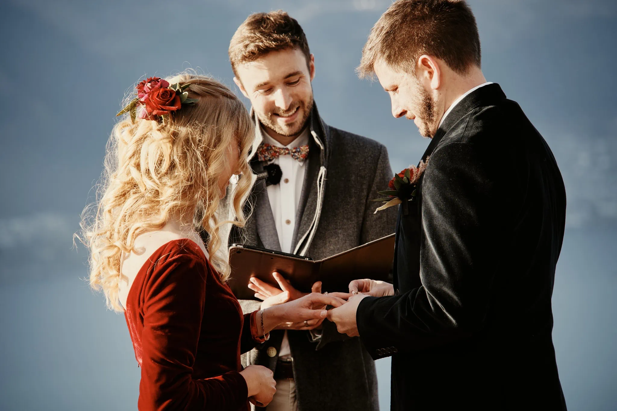 Claire and Rob exchange rings during their heli elopement wedding at Cecil Peak.
