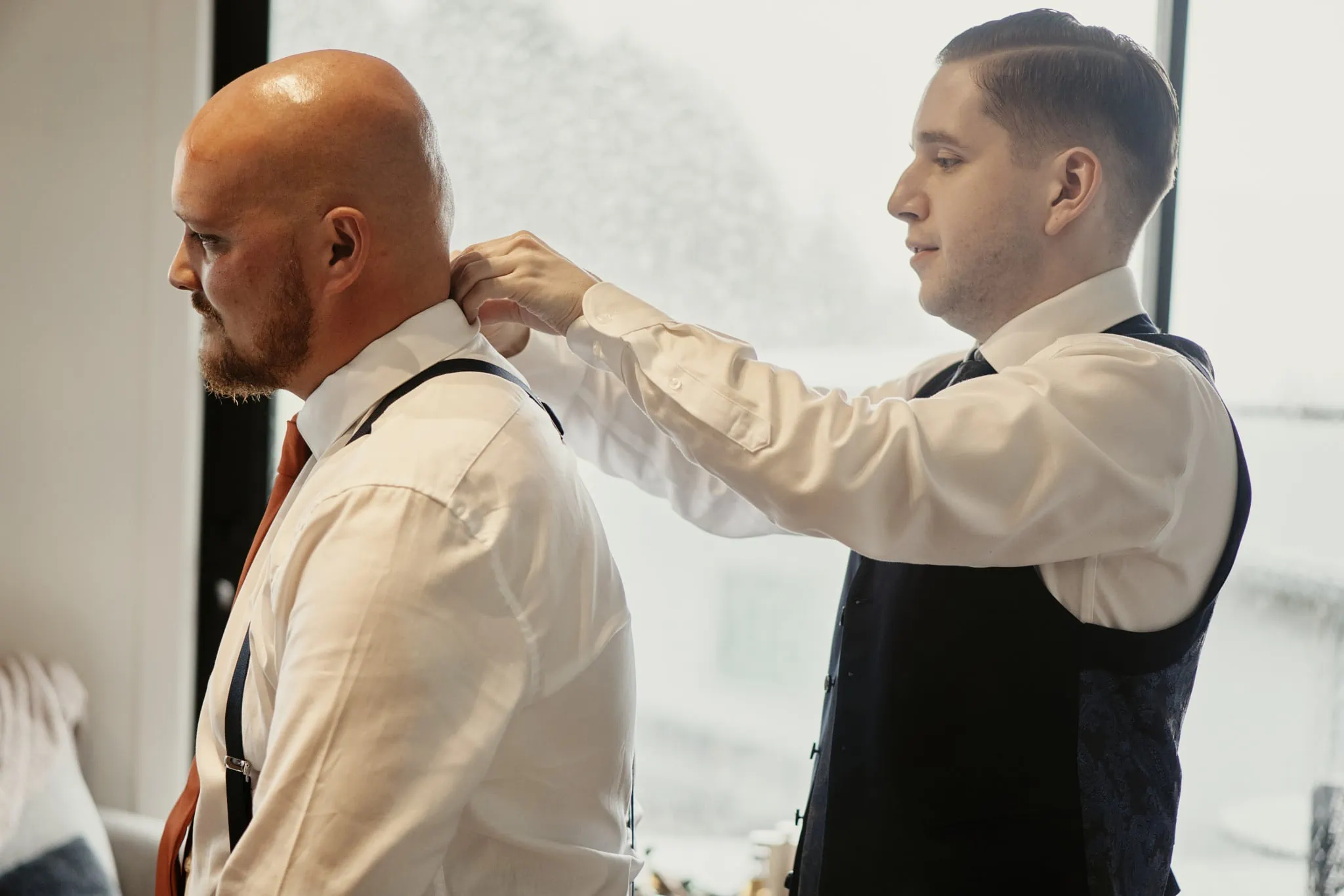 A man, Lenny, confidently wearing a tie at Brett's Kamana Lakehouse wedding.