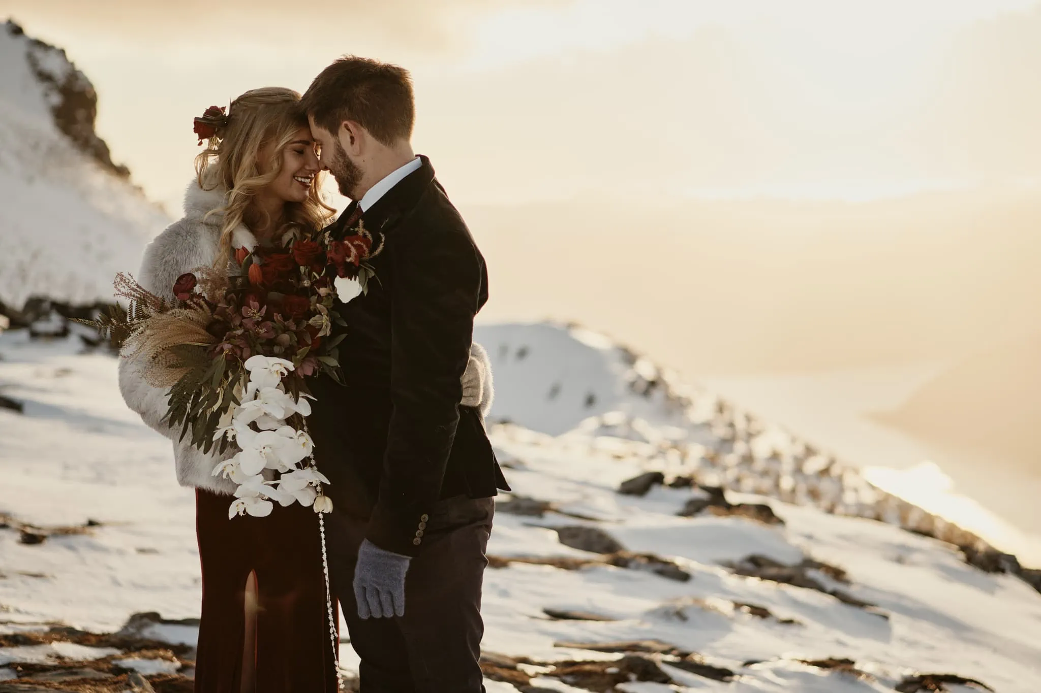 Claire and Rob embrace on top of Cecil Peak during their heli elopement wedding.