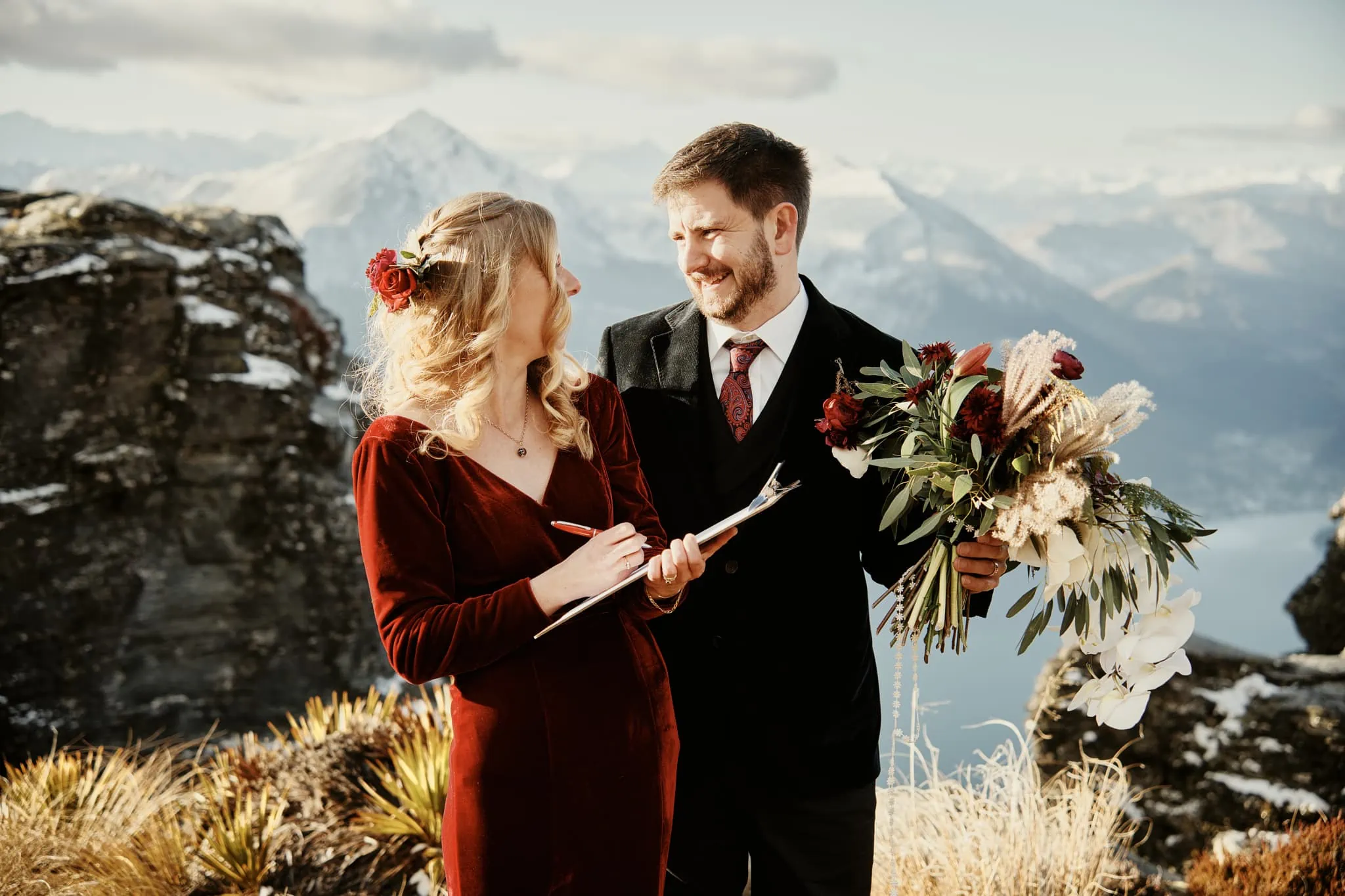 Claire and Rob exchange floral vows during their heli elopement wedding on Cecil Peak.