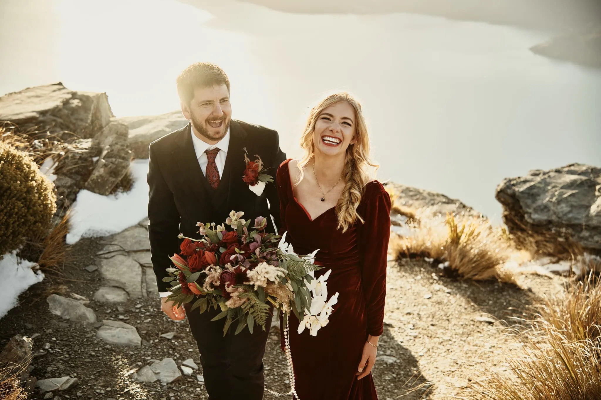 Claire and Rob's heli elopement wedding at Cecil Peak with flowers in their hands.