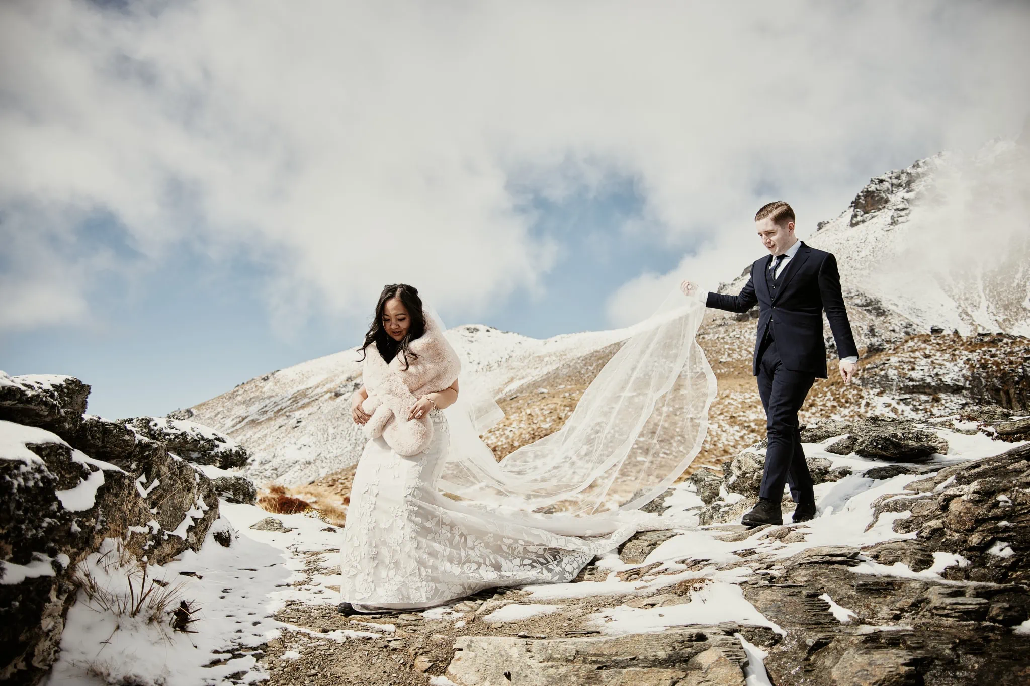Lenny and Brett take their wedding vows at the scenic Kamana Lakehouse, standing on a snow covered mountain.