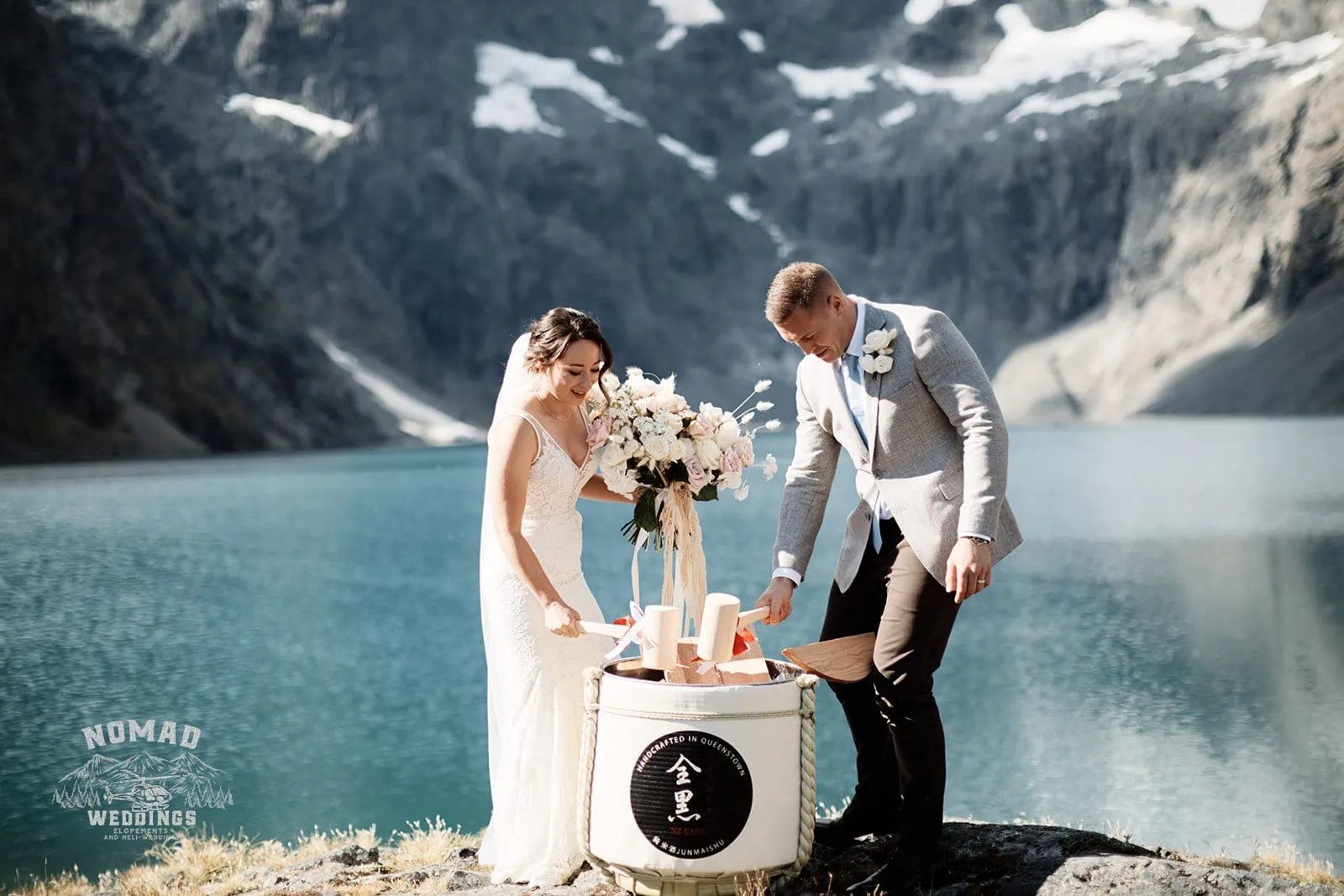 Amy & Eden's enchanting Heli Elopement Wedding at Lake Erskine with mountains in the background.