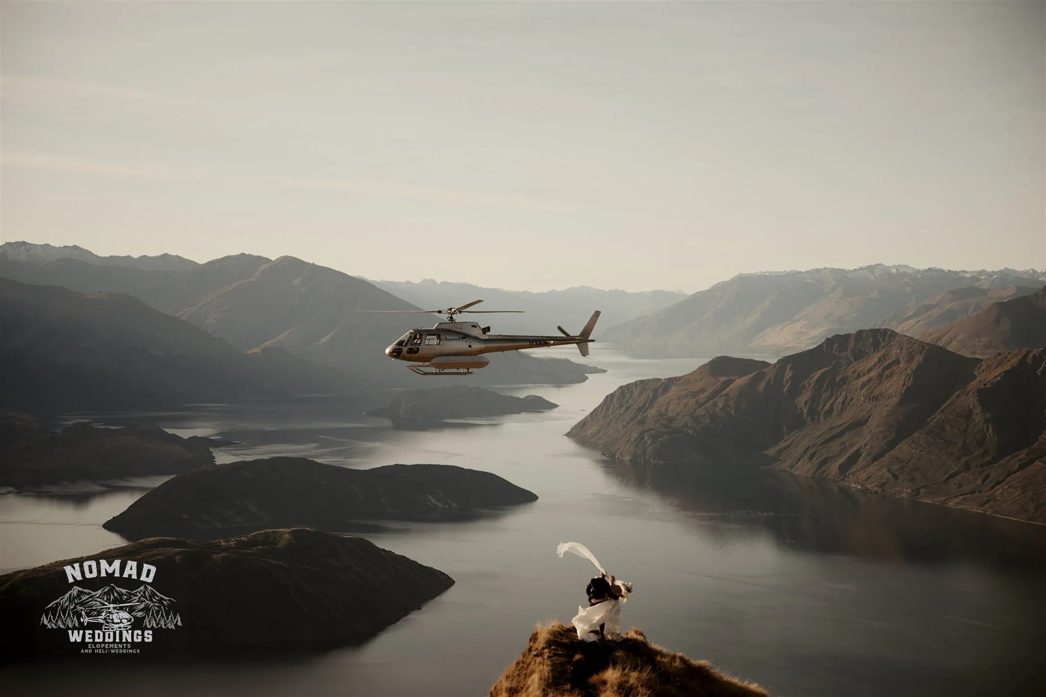 Jay and Dave exchange vows in a breathtaking Coromandel Peak Heli Elopement Wedding, with a helicopter soaring overhead.