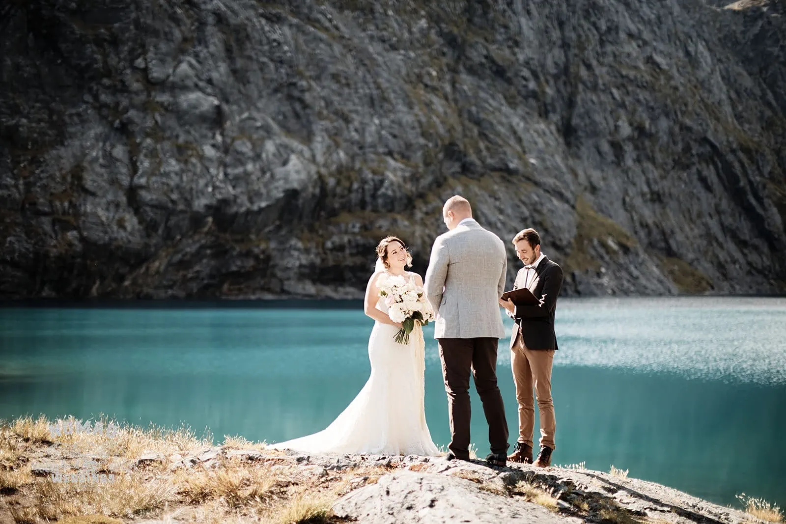 Amy & Eden exchange vows during their enchanting Lake Erskine heli elopement wedding.