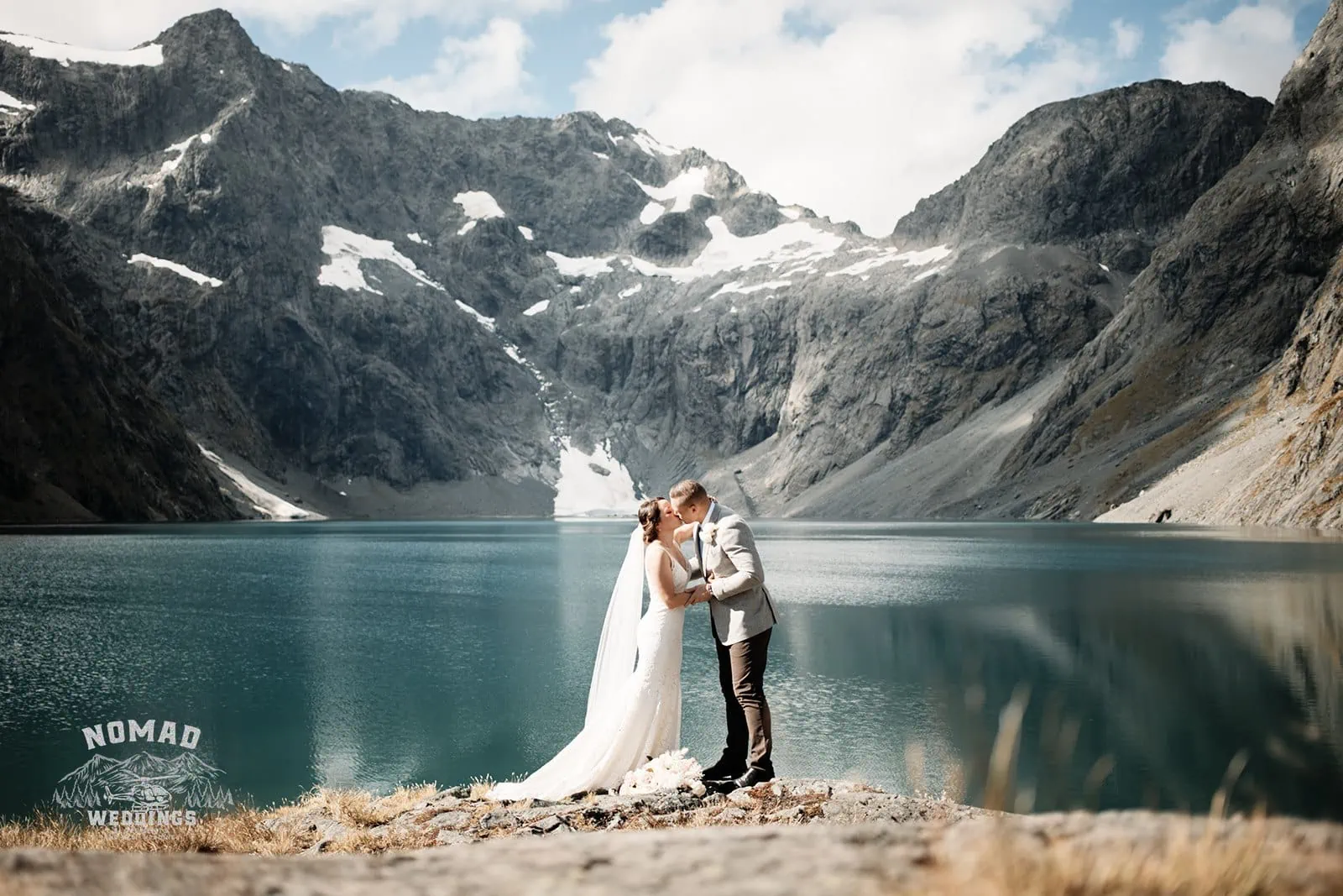 Amy and Eden share an enchanting kiss during their Lake Erskine heli elopement wedding.