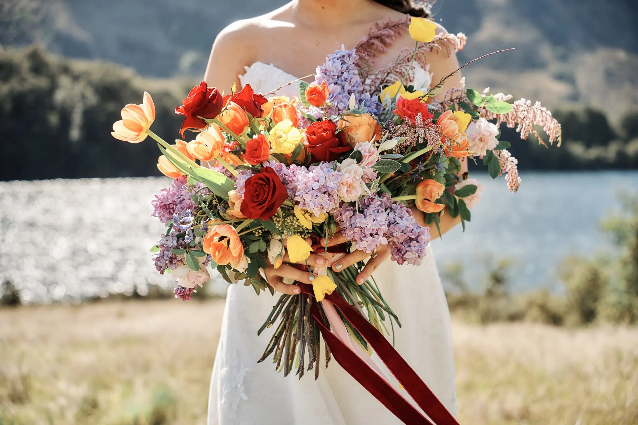 A colorful bouquet in front of Moke Lake for Ace and Alex's pre-wedding shoot.