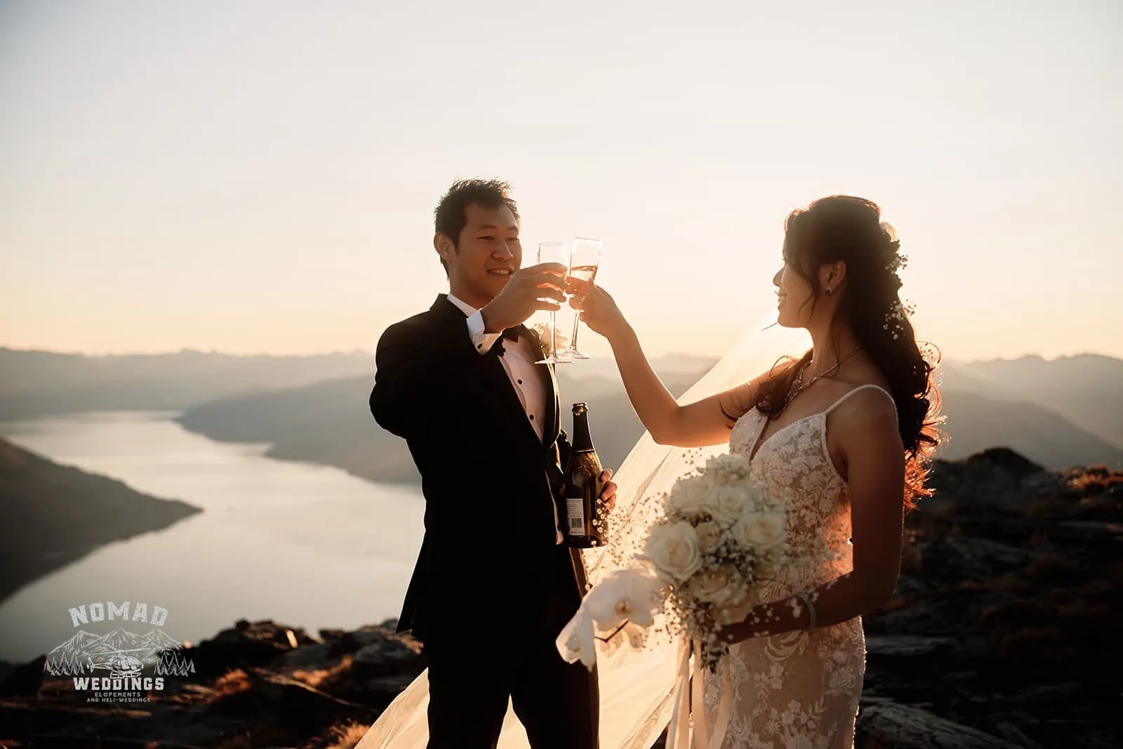 Connie and Andrew toasting wine on top of The Remarkables during their Heli Pre Wedding Shoot.