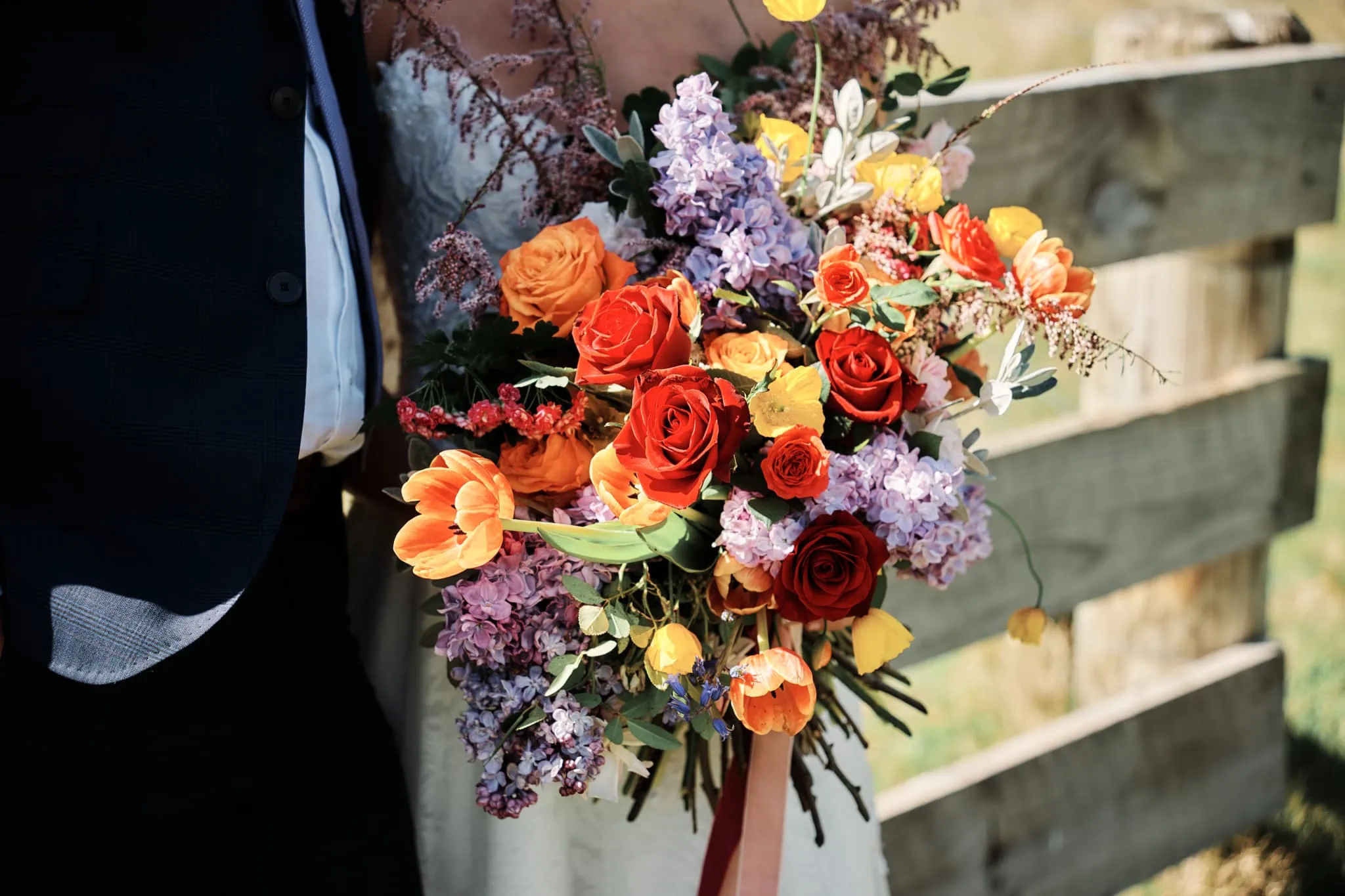 Ace and Alex posing with a bouquet during their Moke Lake pre-wedding shoot.