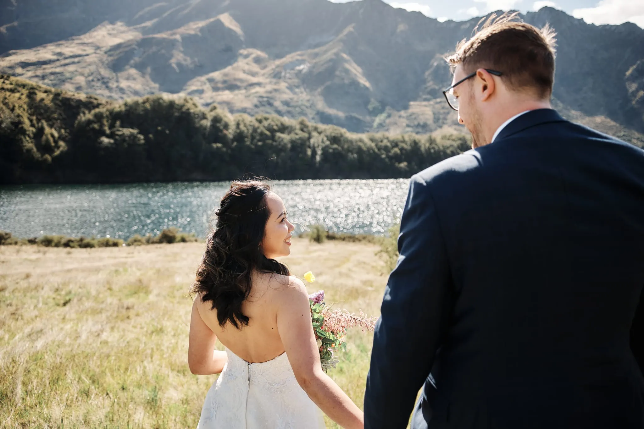 Ace and Alex embrace while standing by Moke Lake in a pre-wedding shoot.
