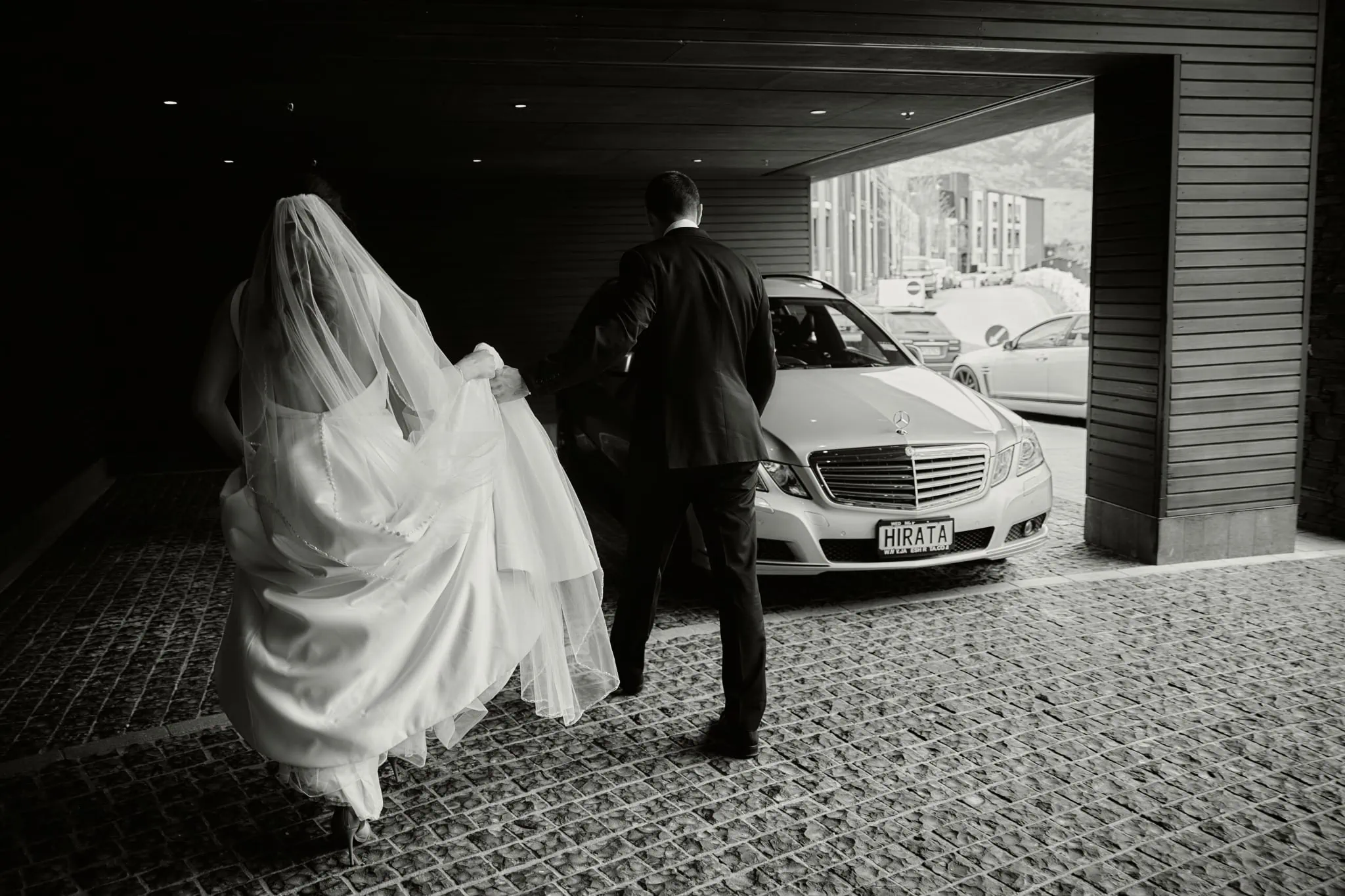 Michelle and Vedran having a Rees Valley Station elopement wedding, walking away from a Mercedes Benz.