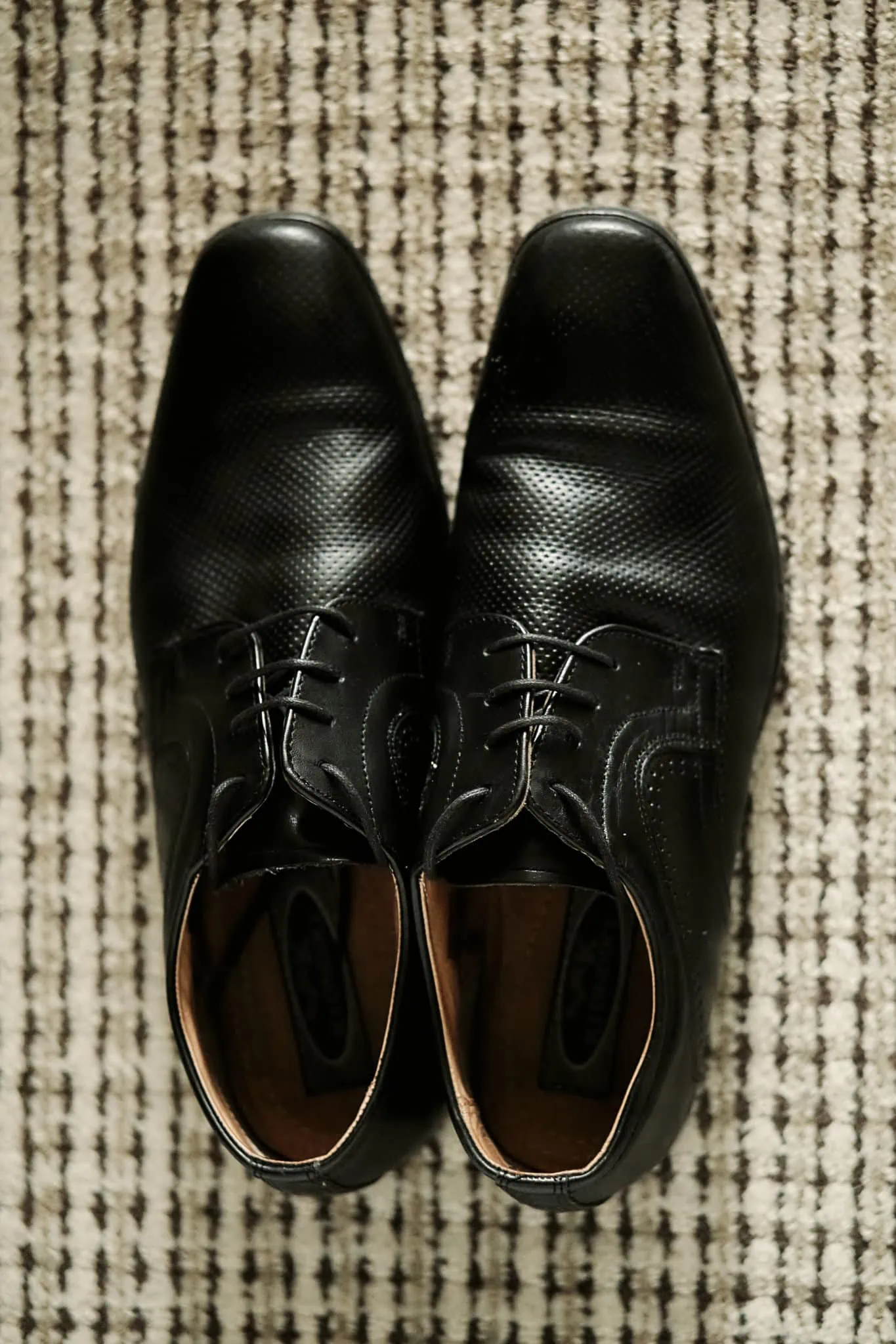 A pair of black shoes on a carpet at Michelle and Vedran's Rees Valley Station Elopement Wedding.