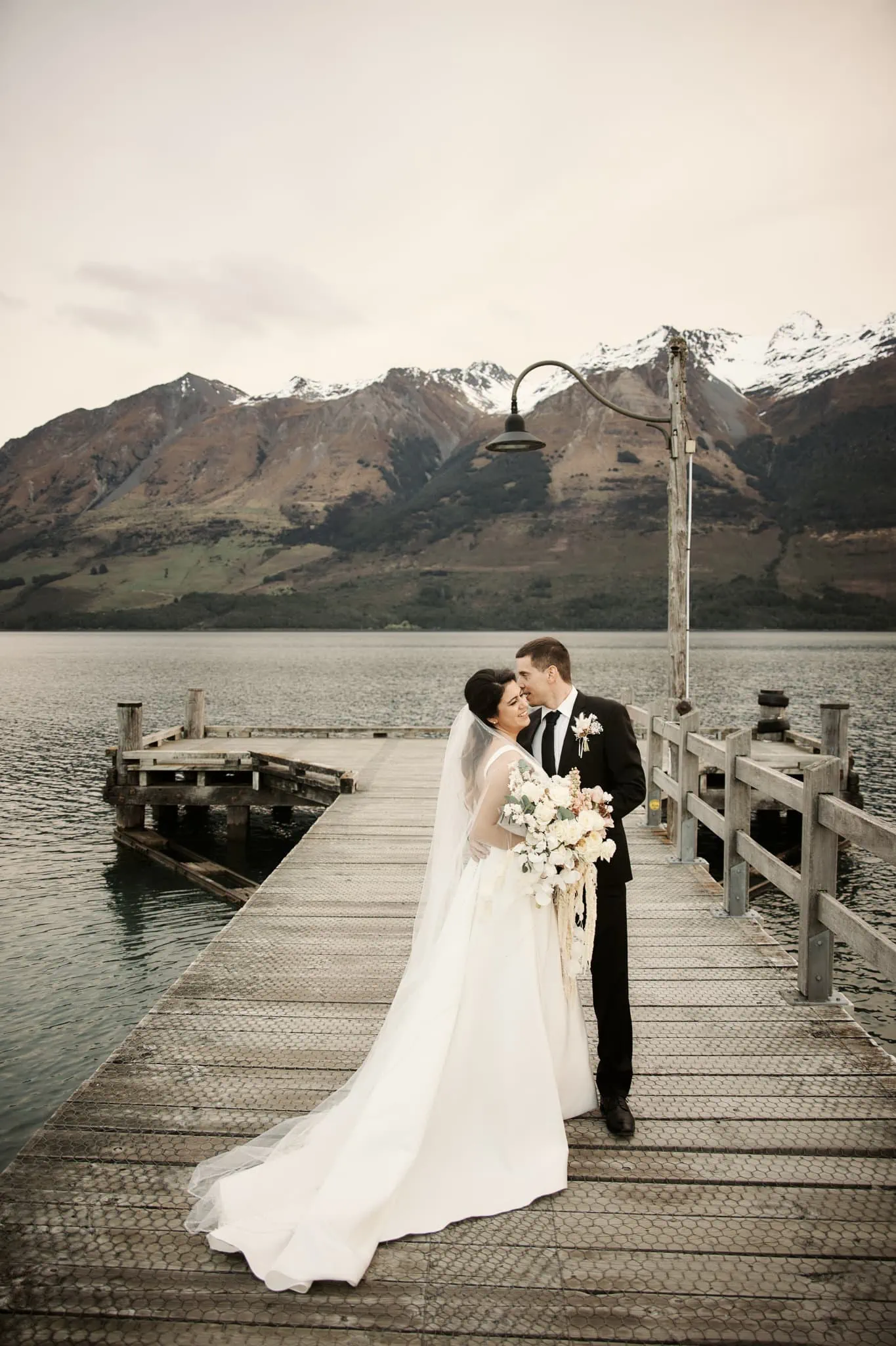 Michelle and Vedran sharing a romantic kiss during their Rees Valley Station elopement wedding at Lake Wanaka.