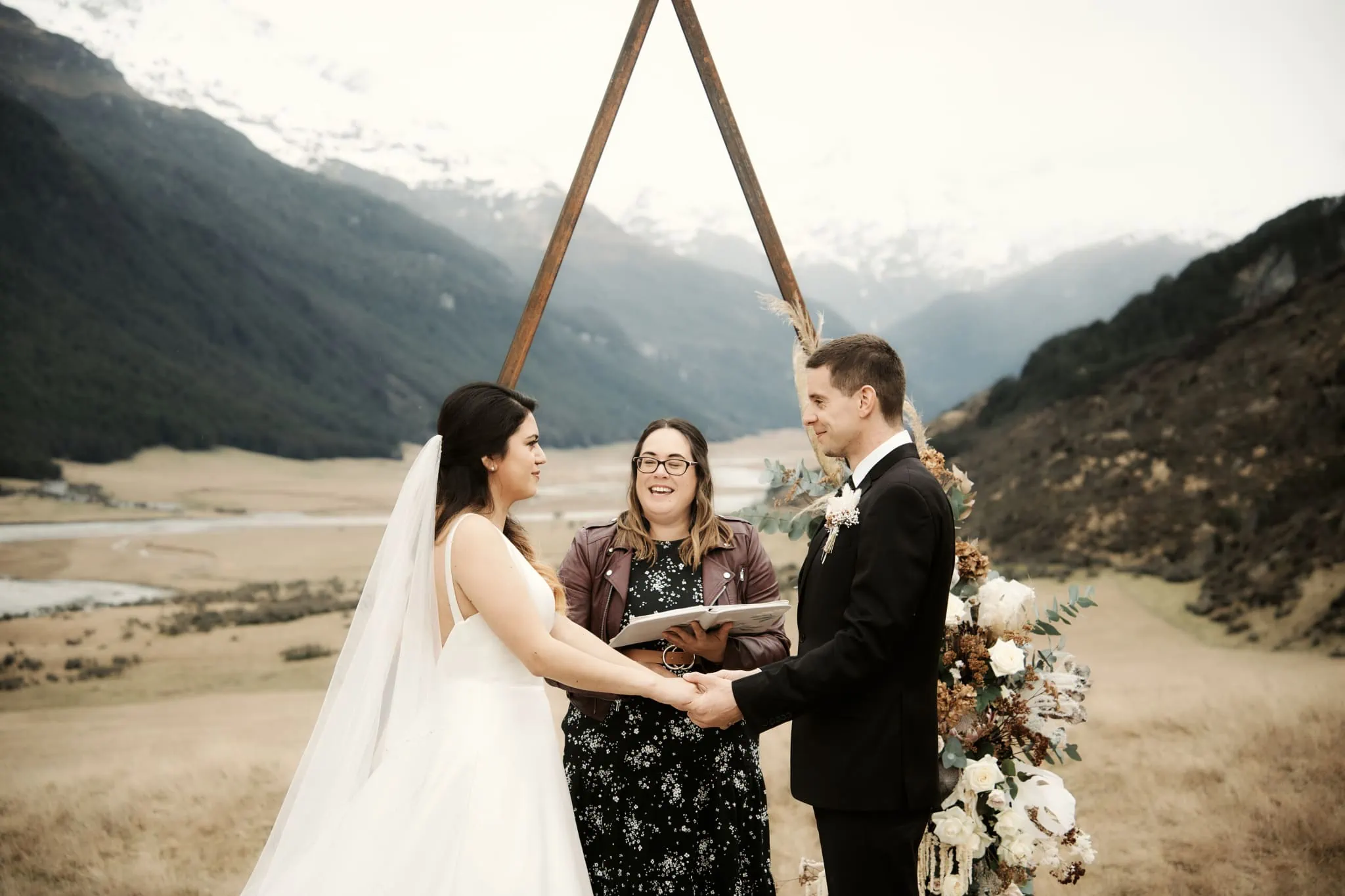 Michelle and Vedran elope, exchanging vows in front of a mountain at Rees Valley Station in New Zealand.
