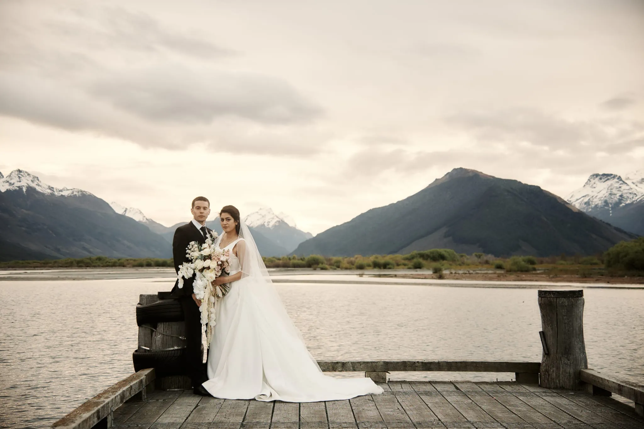 Michelle and Vedran celebrate their Rees Valley Station elopement wedding on a dock with breathtaking mountain views.