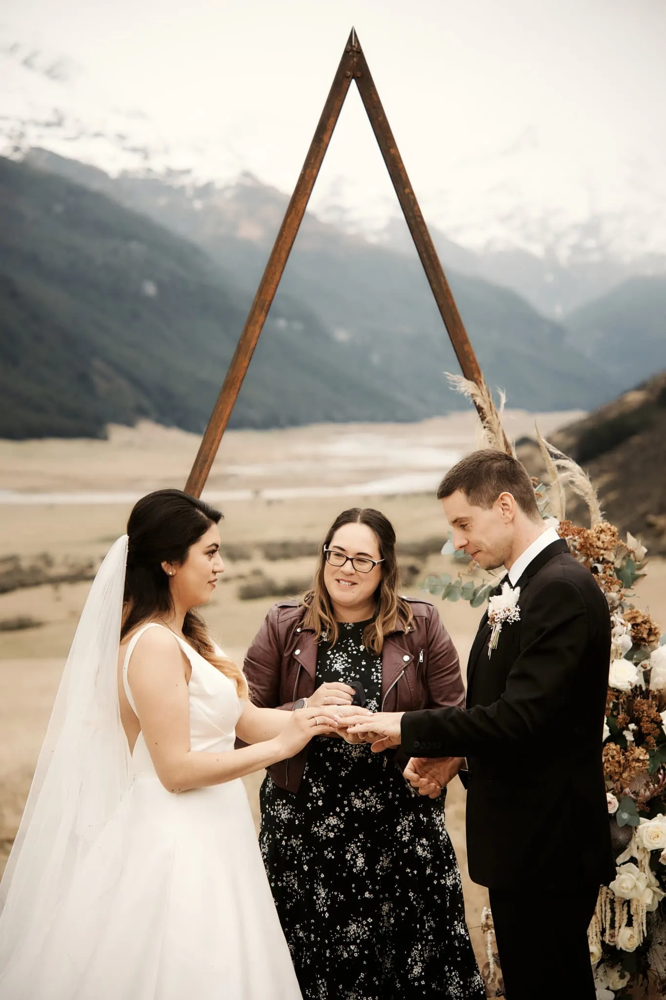 Michelle and Vedran's elopement wedding at Rees Valley Station features a breathtaking ceremony where they exchange vows against the backdrop of majestic mountains.