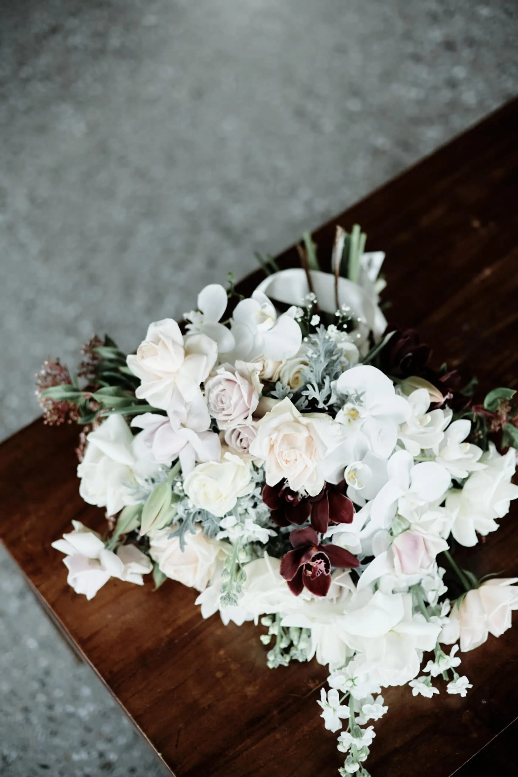 A bouquet of flowers on a wooden table at Stephanie and Carven's Heli Pre Wedding Elopement at The Remarkables.