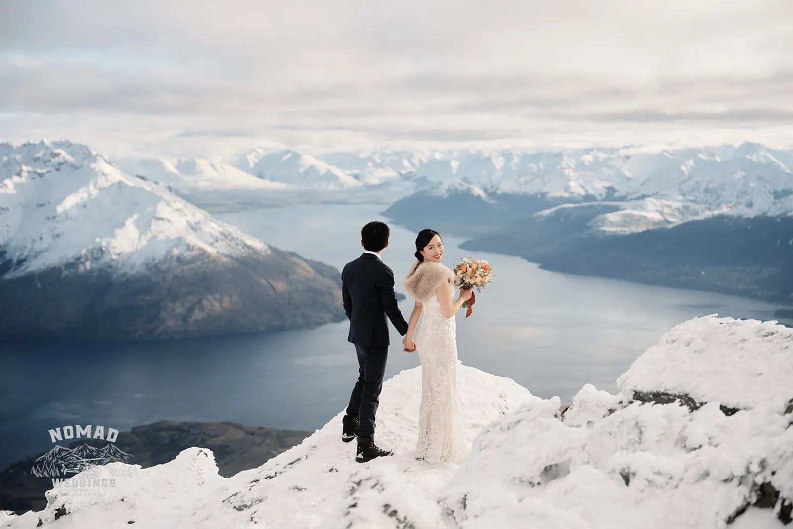 A Pre-wedding Shoot with Joanna and Tony, capturing the bride and groom on top of a mountain overlooking Lake Wanaka in Queenstown, New Zealand.