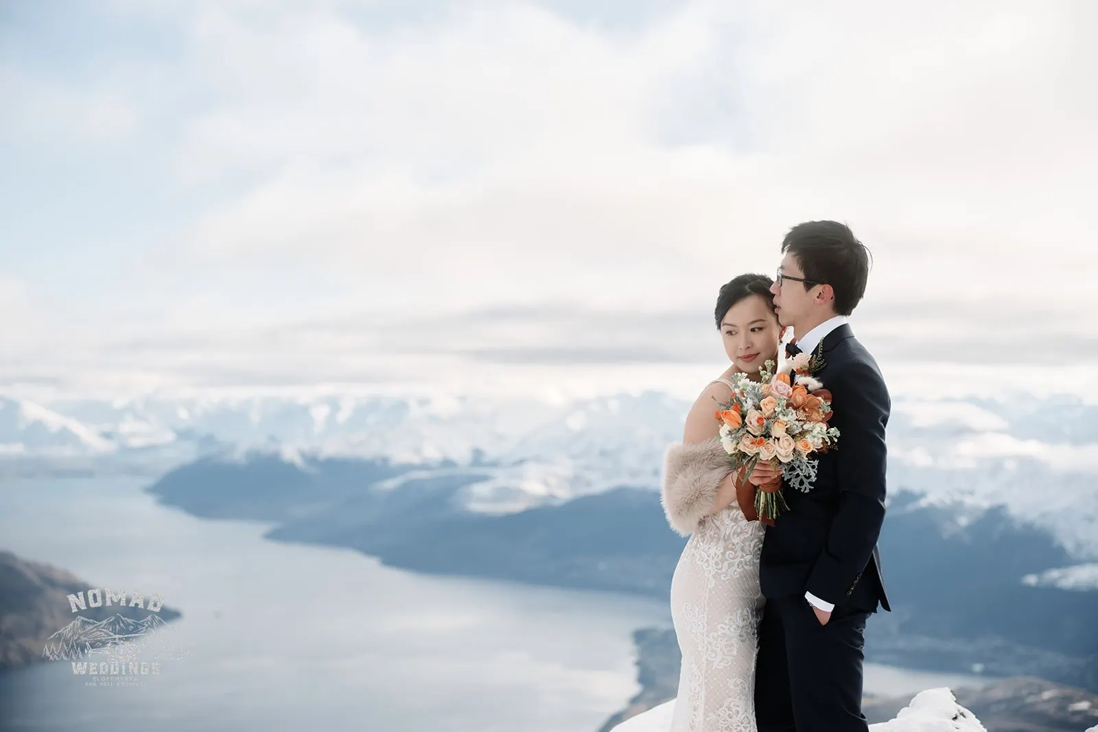 Joanna and Tony, a bride and groom from New Zealand, capturing their pre-wedding shoot on top of a mountain overlooking Lake Wanaka near Queenstown.