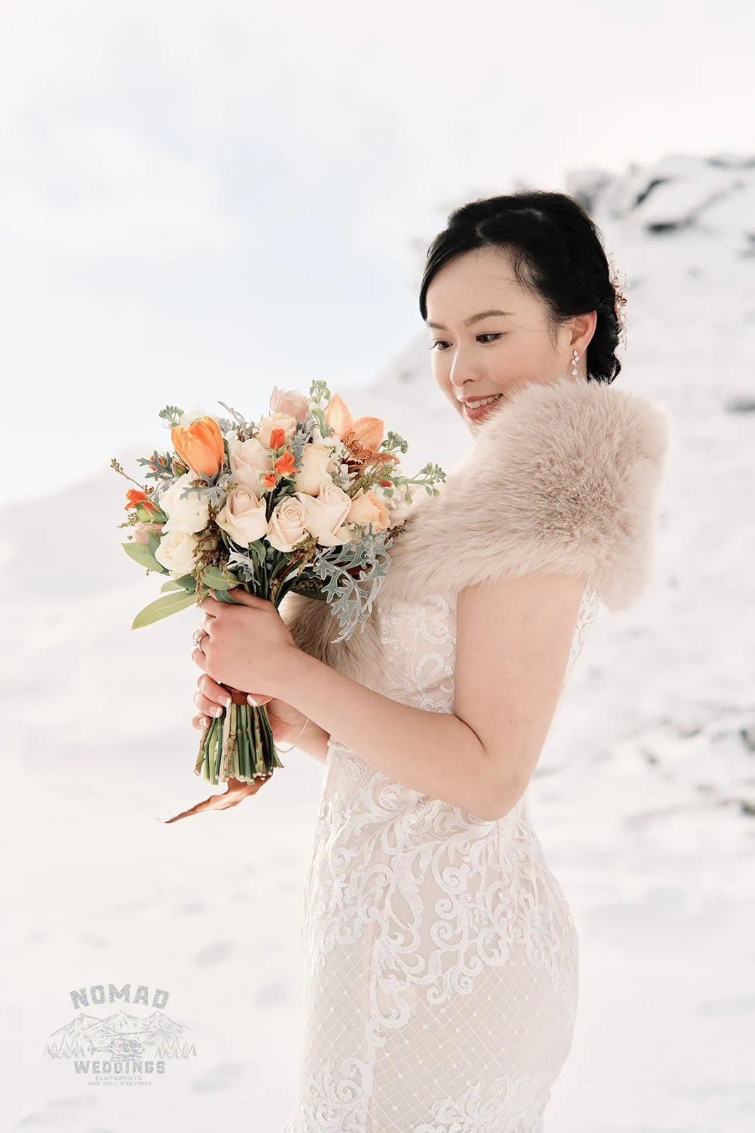 A snow-filled pre-wedding shoot in Queenstown, New Zealand, featuring bride Joanna holding a bouquet.